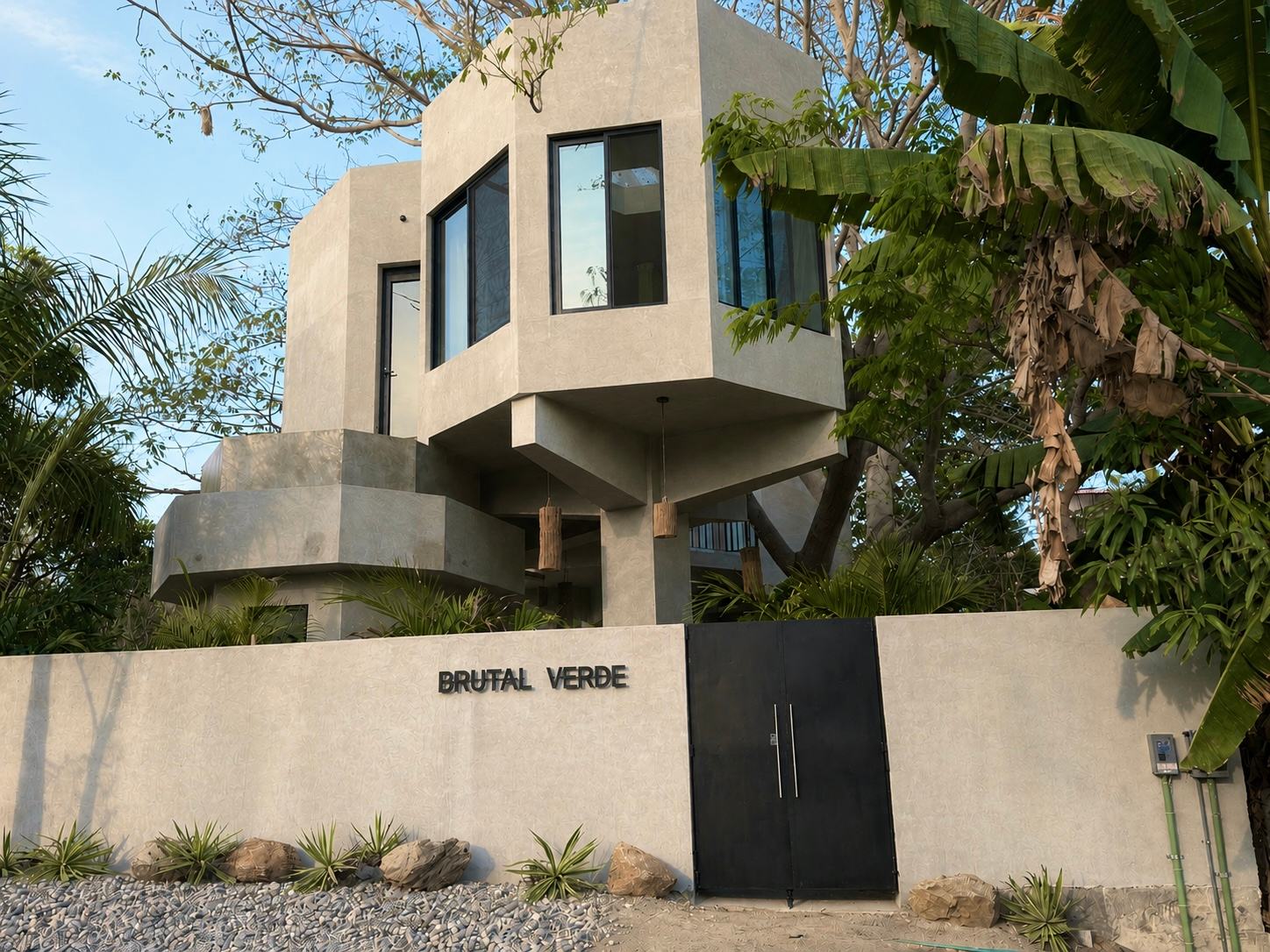 The brutalist concrete house of Brutal Verde rising out of the tropical canopy