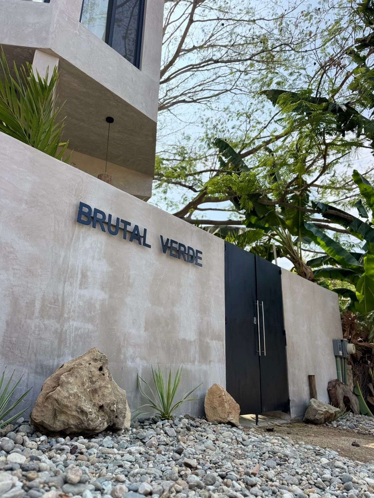 The Brutal Verde name set into the concrete entrance wall